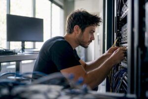 Hands adjusting server hardware in agency