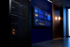 Secured server rack beside monitoring display